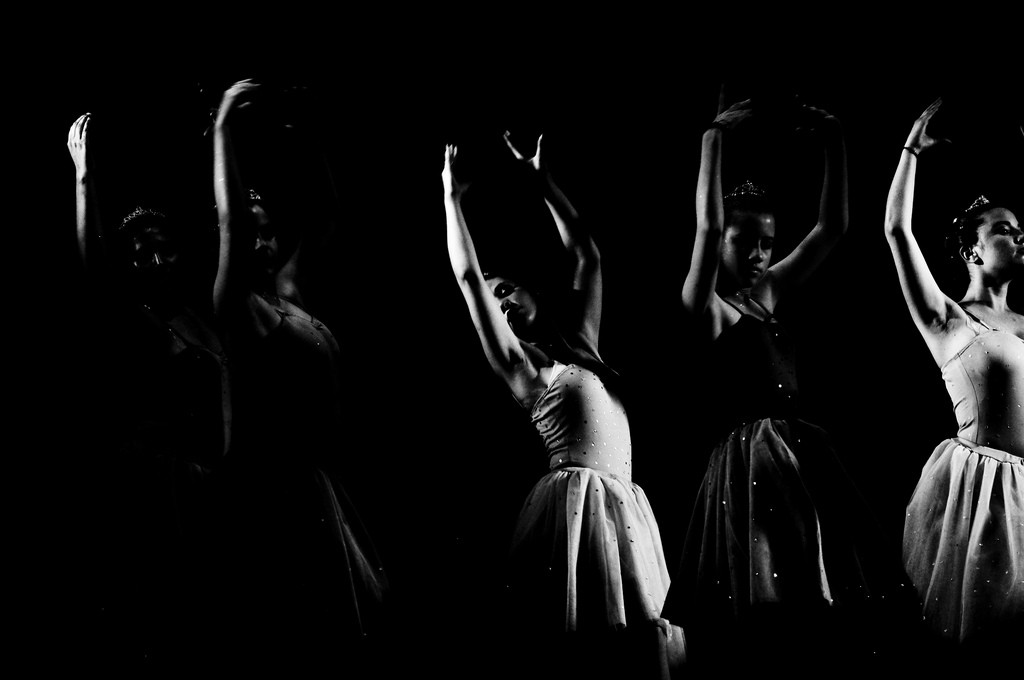 group of dancers with arms raised