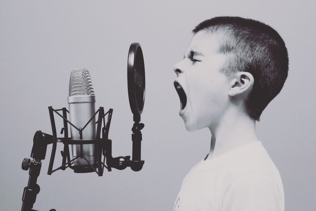 boy yelling into a microphone