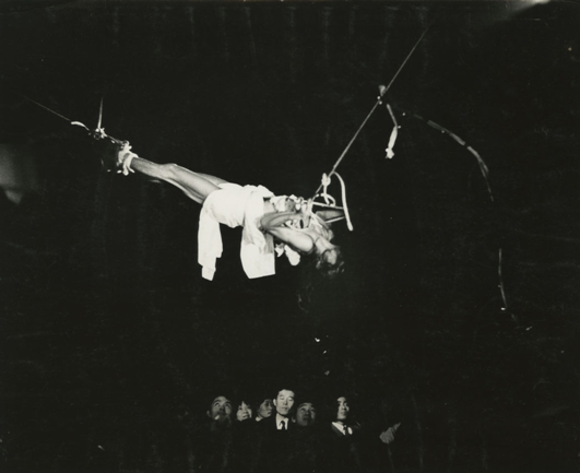 image: Hijikata lifted above the crowd at the culmination of the performance. 