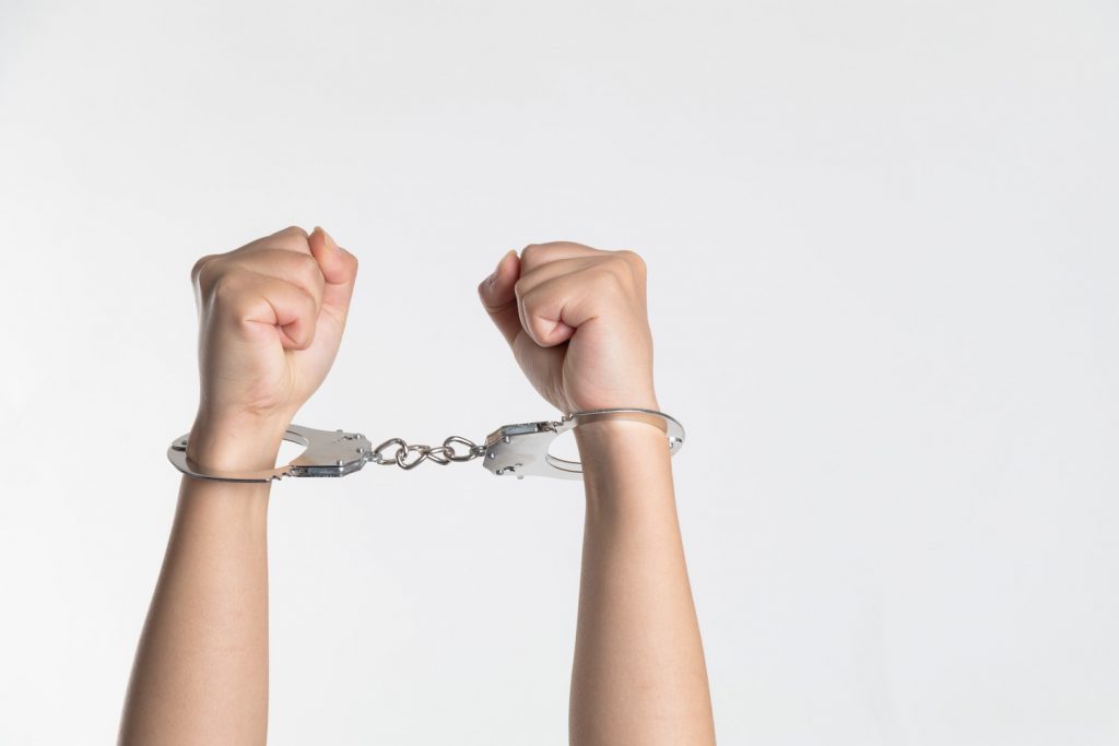 decorative image: arms in handcuffs