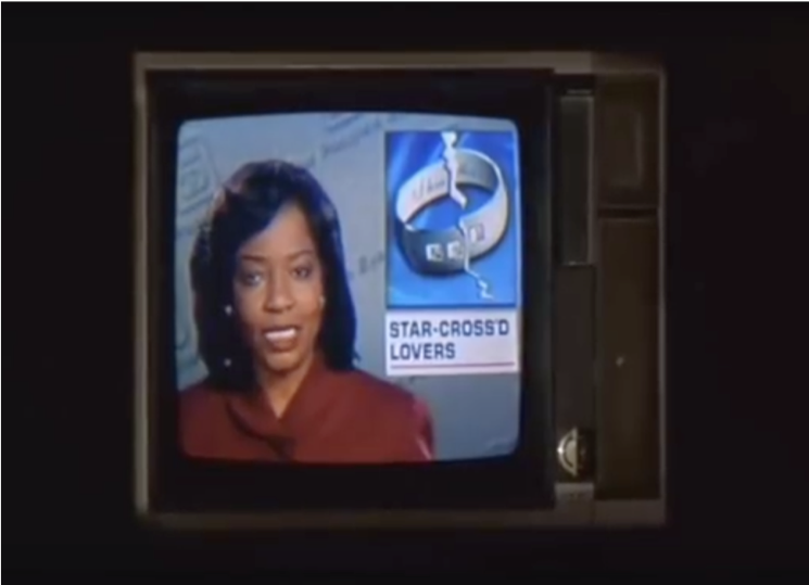 screen shot from movie: newscaster on TV screen