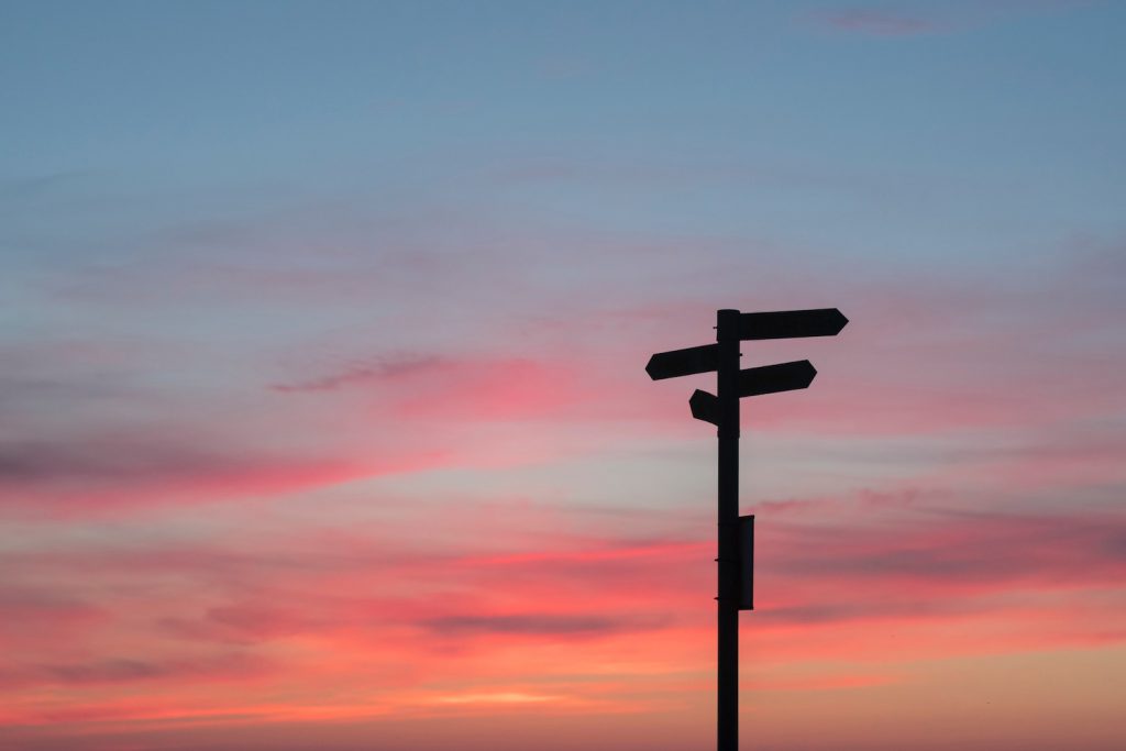 deco image: road sign again sunset sky