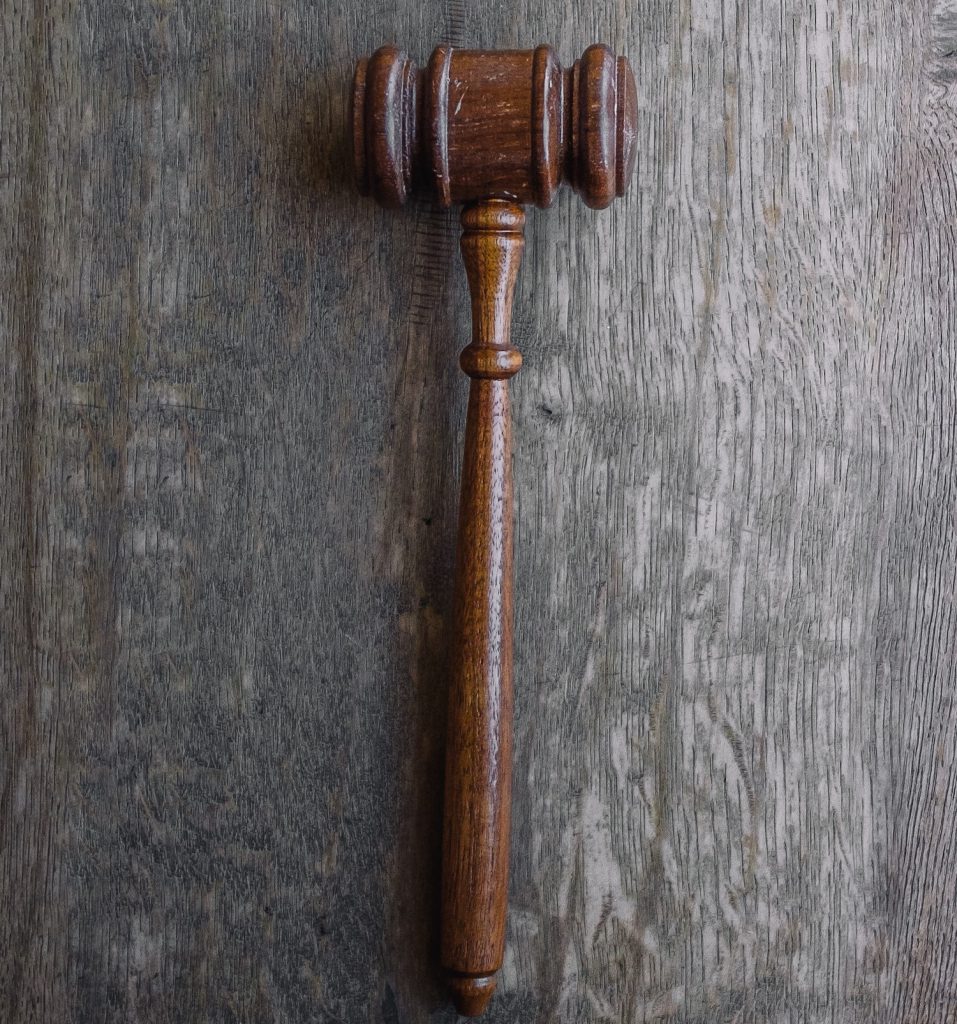 decorative image: brown mallet on gray wooden surface