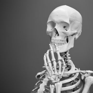 deco image: skeleton in thinking pose
