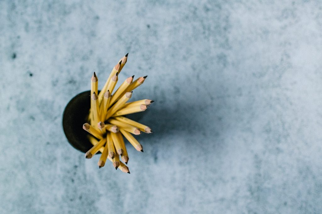 cup of pencils against granite surface